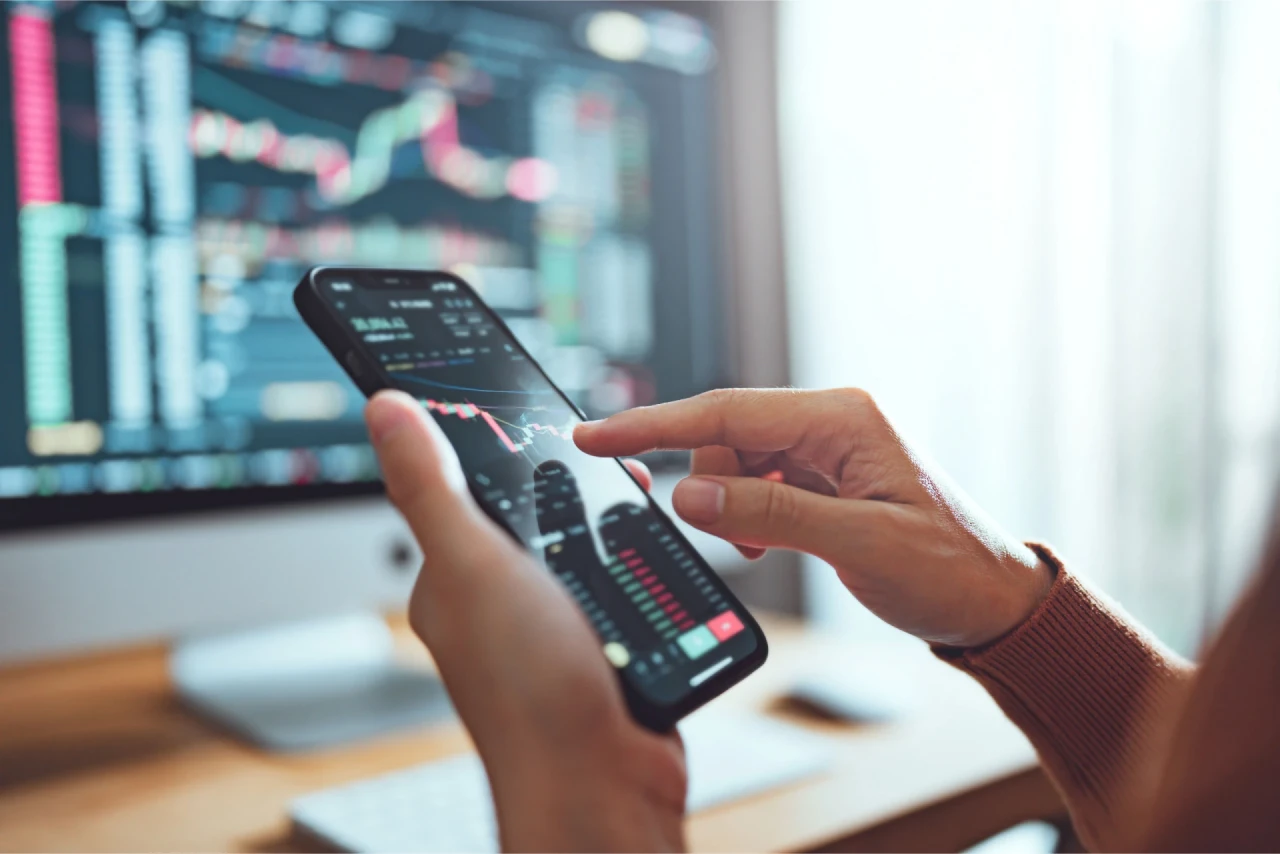 Mobile phone displaying real-time trading data, illustrating the concept of a currency pair in forex.